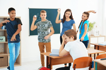 Teenagers bullying their classmate in school