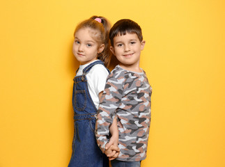 Cute little children on color background