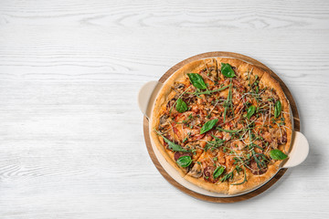 Tasty homemade pizza and space for text on wooden table, top view