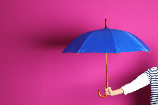 Woman holding beautiful umbrella on color background with space for design