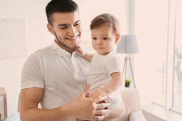 Young dad with his little son at home