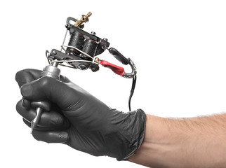 Professional tattoo artist with machine on white background