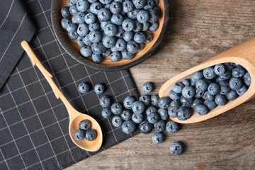 Flat lay composition with juicy blueberries on wooden table