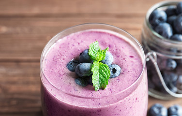 Blueberry smoothie with mint on table, closeup