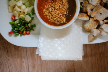 minced pork sausage, fermented rice noodle & vegetable served with chili sauce. vietnamese food called Nem Nuong Xa