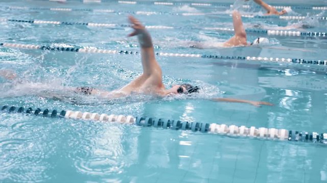 Slow motion swimmer competition or training at swimming pool