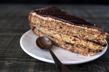 Tasty piece of chocolate cake on wooden table background