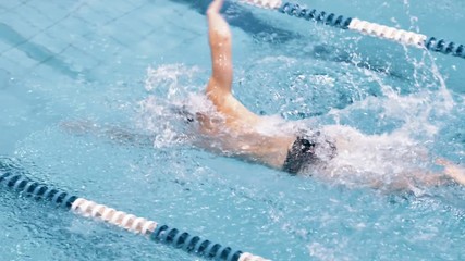 High angle training of muscular professional young swimmers in swimming pool slow motion