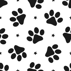 Fototapeta na wymiar Repeated silhouettes of paw prints and stars. Seamless pattern for animals.