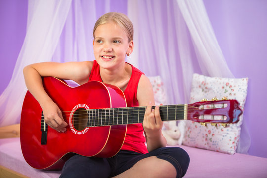 Teenage girl with her guitar in her lovely room&uml;