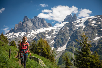 Fototapeta na wymiar Pretty, female hiker/climber in a lovely alpine setting of Swiss Alps