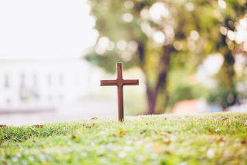The cross standing on meadow sunset and bokeh background.Cross on a hill as the morning sun comes...