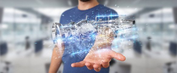 Businessman using wireframe holographic 3D digital projection of an engine