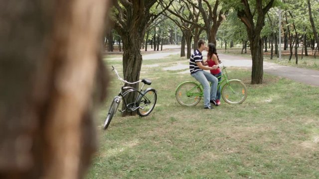 HD Peeping of Couple on bikes kissing outdoors.