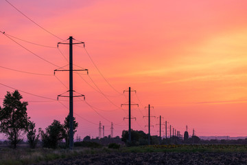 Rural landscape with high-voltage line on sunset