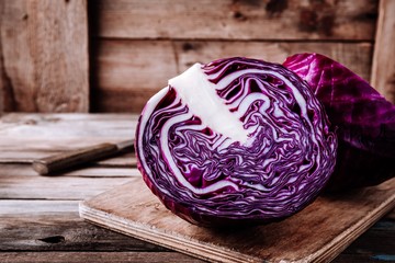 Cutted fresh organic red cabbage on wooden background