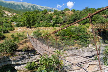 View of the old, destroyed bridge over the river Viosa, south Albania.