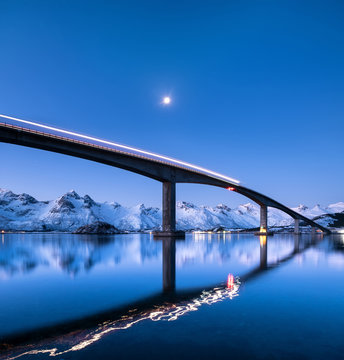 Bridge and reflection on the water surface. Natural landscape in the Lofoten islands, Norway. Architecture and landscape.