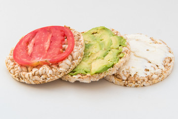 round crispbreads with tomatoes avocado and chees