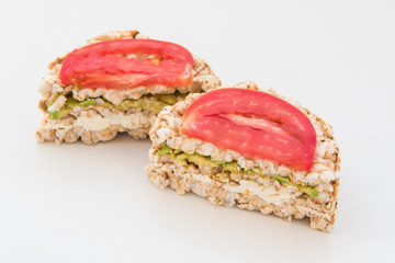 round crispbreads with tomatoes avocado and chees