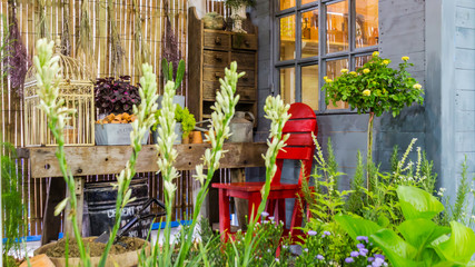 Fototapeta na wymiar Relaxing area in cozy home garden on summer./ Relaxing area with garden object and tools decoration on table in cozy home garden on summer. 