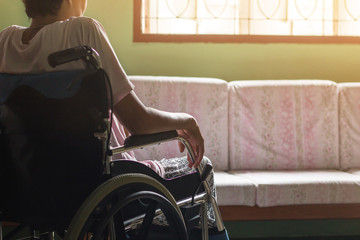 Asian senior or elderly old lady woman patient on wheelchair looking out the window so sad at home,healthy strong medical concept - obrazy, fototapety, plakaty