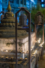 Buddhist prayer wheel illuminated with candles for festival in Nepal