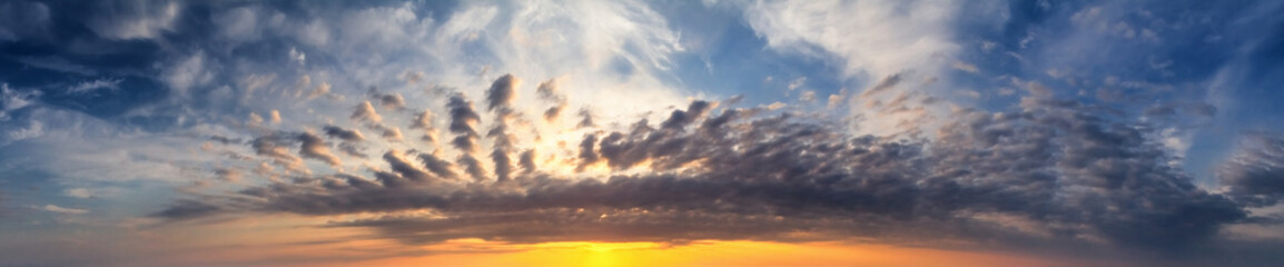 Naklejka na ściany i meble Beautiful summer sunset with a cloudy sky, panorama, banner