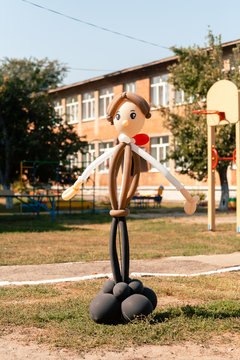 Balloon man dolly in the summer sun on school garden