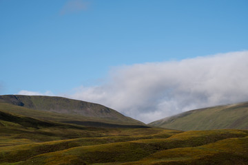 View of hills in Scottish Highlands on a clear summer's day, with low lying cloud. Photographed early in the morning near Inverness