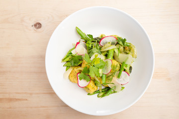 Plate of gnocchi with pesto with fresh local greens.