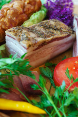 Salted traditional way of pieces of pork, along with chili and vegetables.