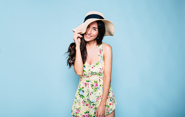 Portrait of cute summer brunette woman in hat and colorful dress, stylish girl have a fun and...