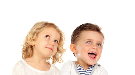 Two blond children looking up