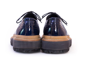 Pair of blue glossy men's shoes isolated on white background