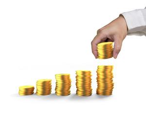 Man's hand arranging golden coins to stack as step stairs, isolated on white background, concept of financial growth success.