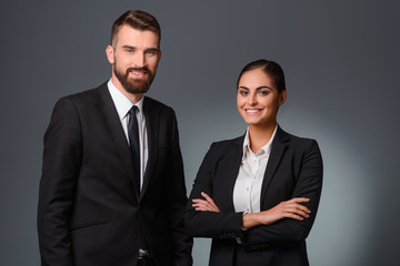 Smiling partners in formal clothing