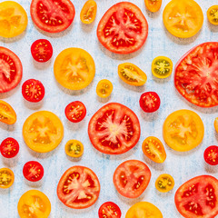 Slices of Tomatoes Over Blue Background
