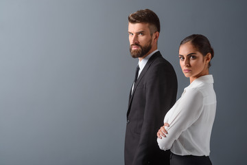 Irritated businesspersons on gray background