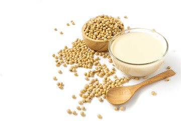 soy beans , soy milk  and wooden spoon isolated on white background .