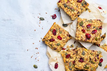 Fotobehang Granola Bars, Superfood Homemade Snack, Healthy Bars with Cranberry, Pumpkin Seed, Oats, Chia and Flax Seed on bright background © julie208