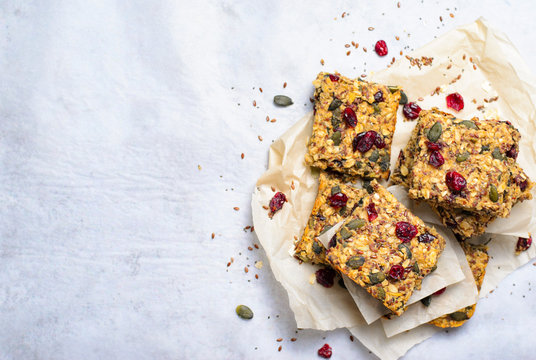 Granola Bars, Superfood Homemade Snack, Healthy Bars with Cranberry, Pumpkin Seed, Oats, Chia and Flax Seed on bright background