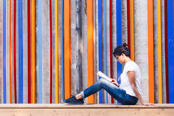 A woman  in sunglasses reads a book