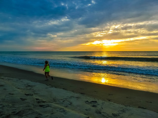 Woman running on the beach at sunset. Florida, USA