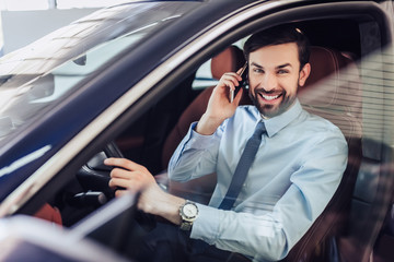 businessman talking on cellphone in the car