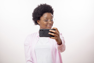 close up portrait woman is holding a smart phone and talking with a friend by skype. technology,...