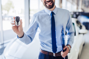 salesman holding car keys