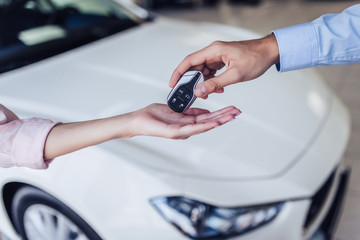 salesman giving keys to woman