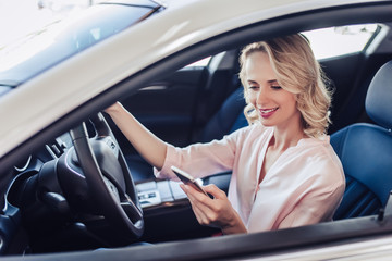 woman in the car using smartphone