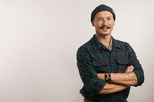 Full length shot of a craftsman standing confidently with his arms folded in the middle of his workshop studio smiling confidently at the camera